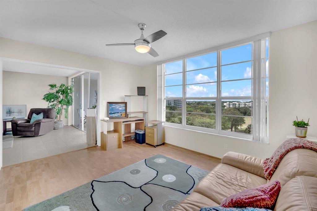 605 Oaks Drive, Unit 907 Pompano Beach, FL 33069 - Photo 8 of 41 a living room with furniture and a large window