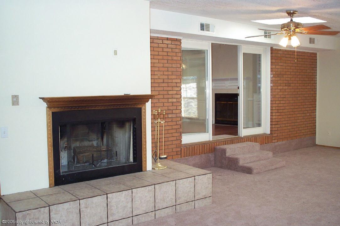 7922 Goodnight Trail Amarillo, TX 79110 - Photo 10 of 18 a view of an empty room with window and fireplace