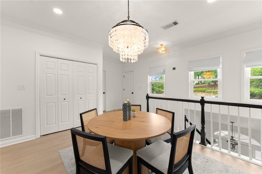 2300 Habersham Marina Road, Unit 302 Cumming, GA 30041 - Photo 5 of 31 a view of a dining room with furniture and wooden floor