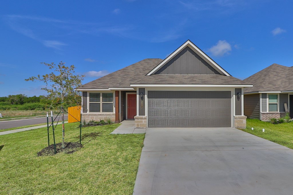 a front view of a house with a yard and garage