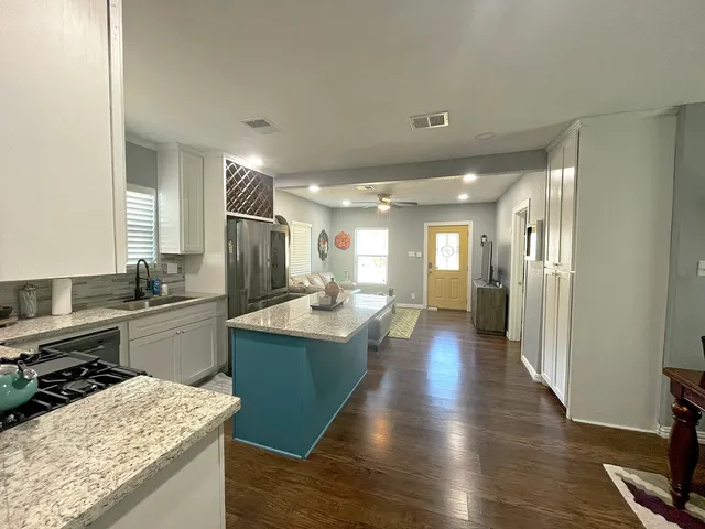 a kitchen with a sink and a refrigerator