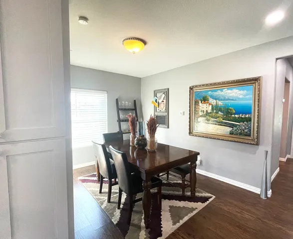 a view of a dining room with furniture and wooden floor