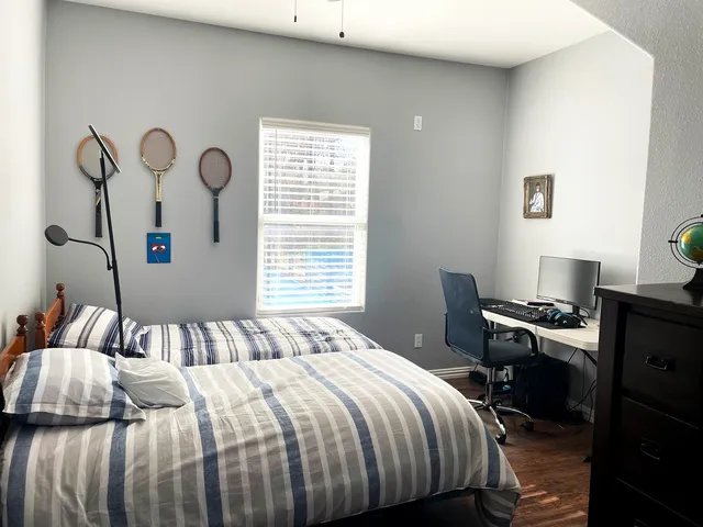 a bedroom with two beds and a chandelier