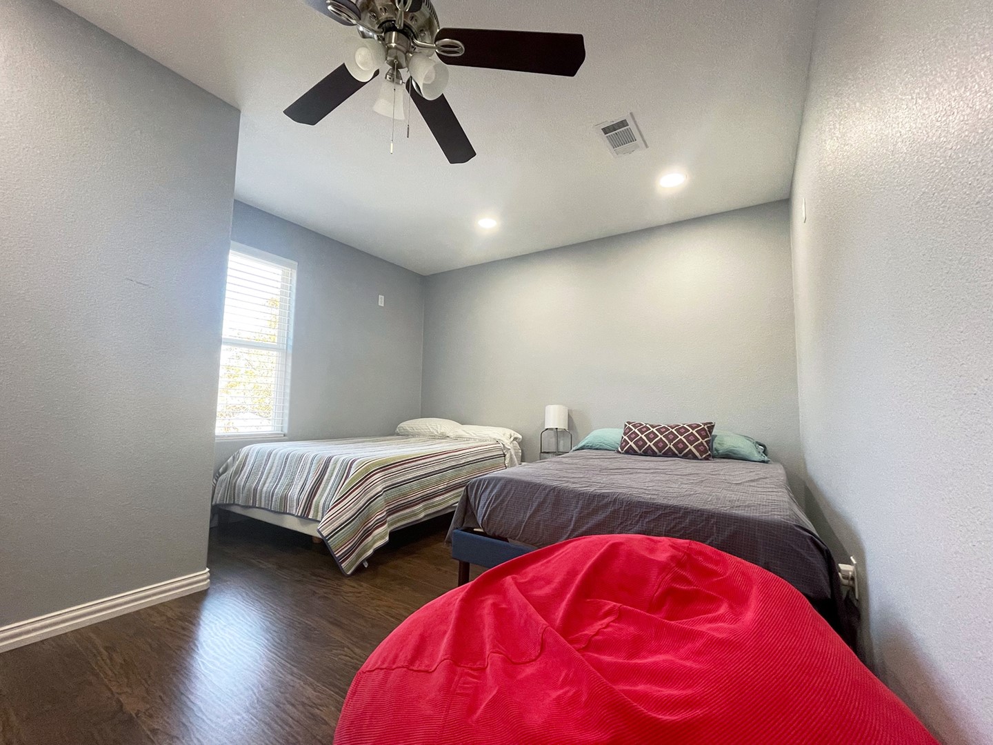 720 Caperton Street Houston, TX 77022 - Photo 22 of 25 a bedroom with two beds and a chandelier