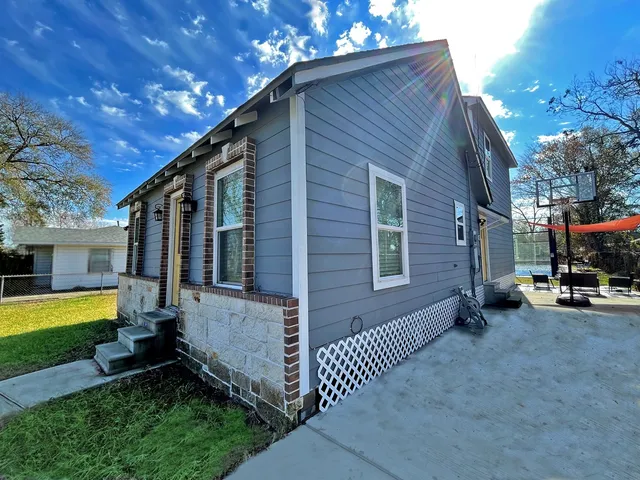 a view of a house with a yard porch and furniture