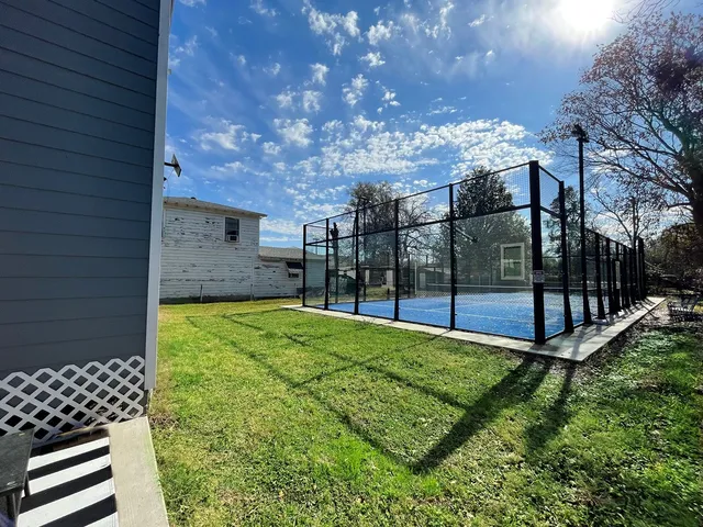 a view of a backyard with wooden fence