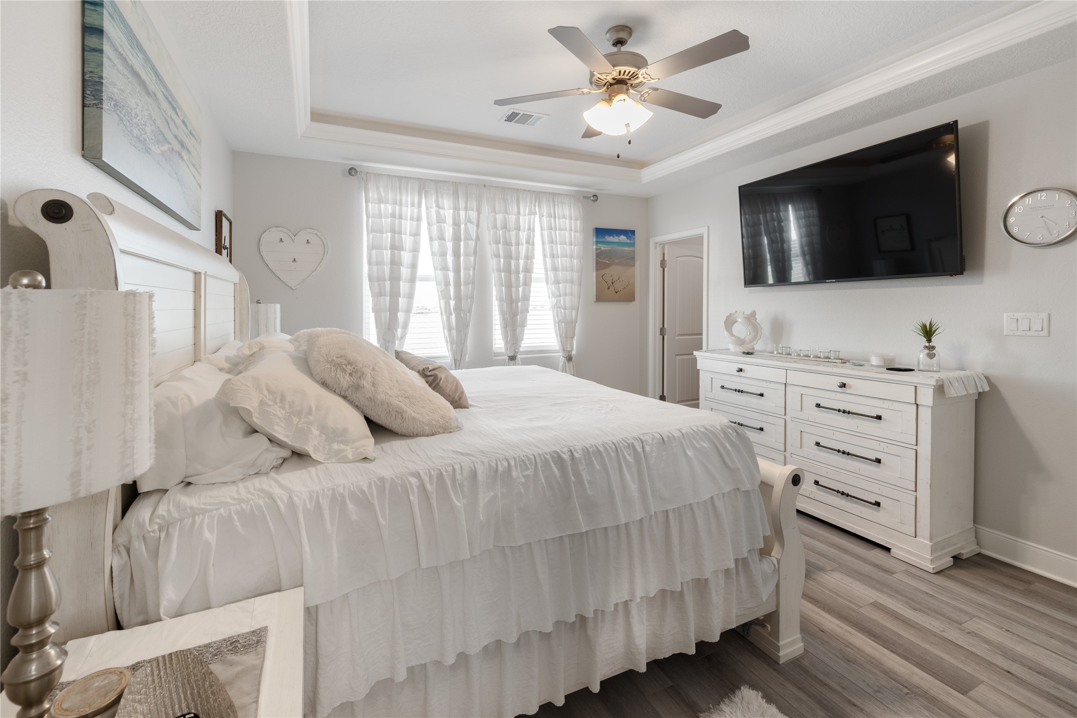 1286 Lagoon Drive Crystal Beach, TX 77650 - Photo 18 of 45 a bedroom with a bed television on dresser and a window