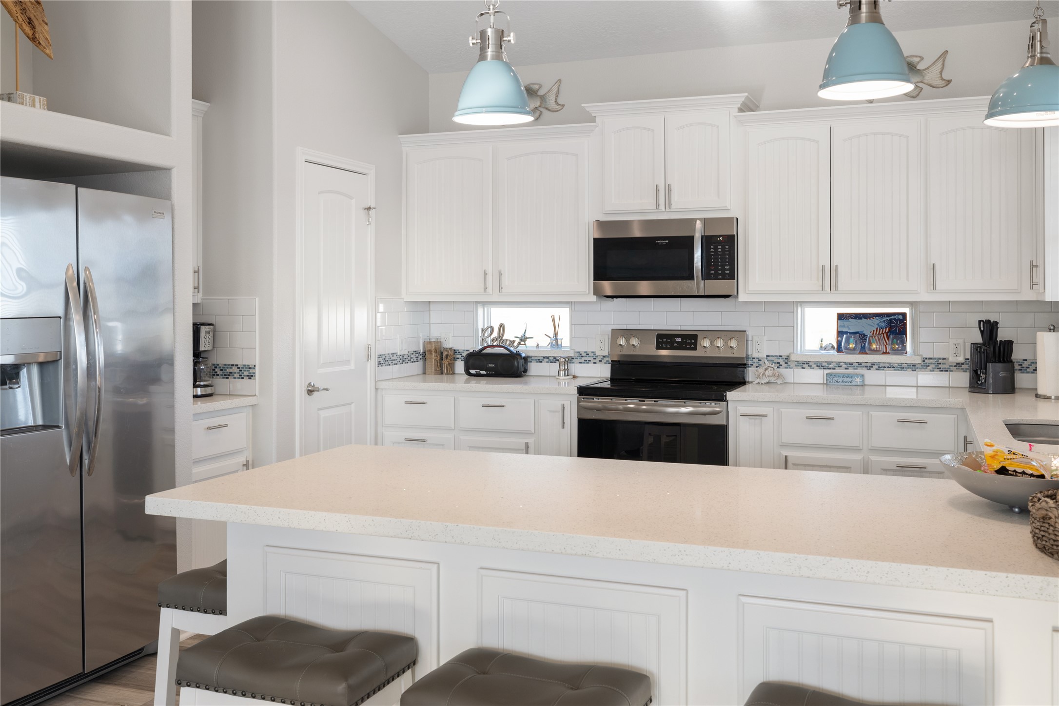 1286 Lagoon Drive Crystal Beach, TX 77650 - Photo 5 of 45 a kitchen with a refrigerator a stove a microwave and cabinets