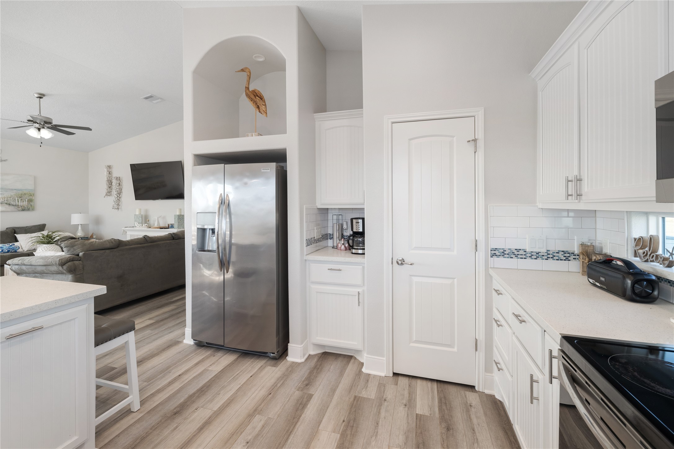 1286 Lagoon Drive Crystal Beach, TX 77650 - Photo 8 of 45 a kitchen with stainless steel appliances a refrigerator a sink and white cabinets