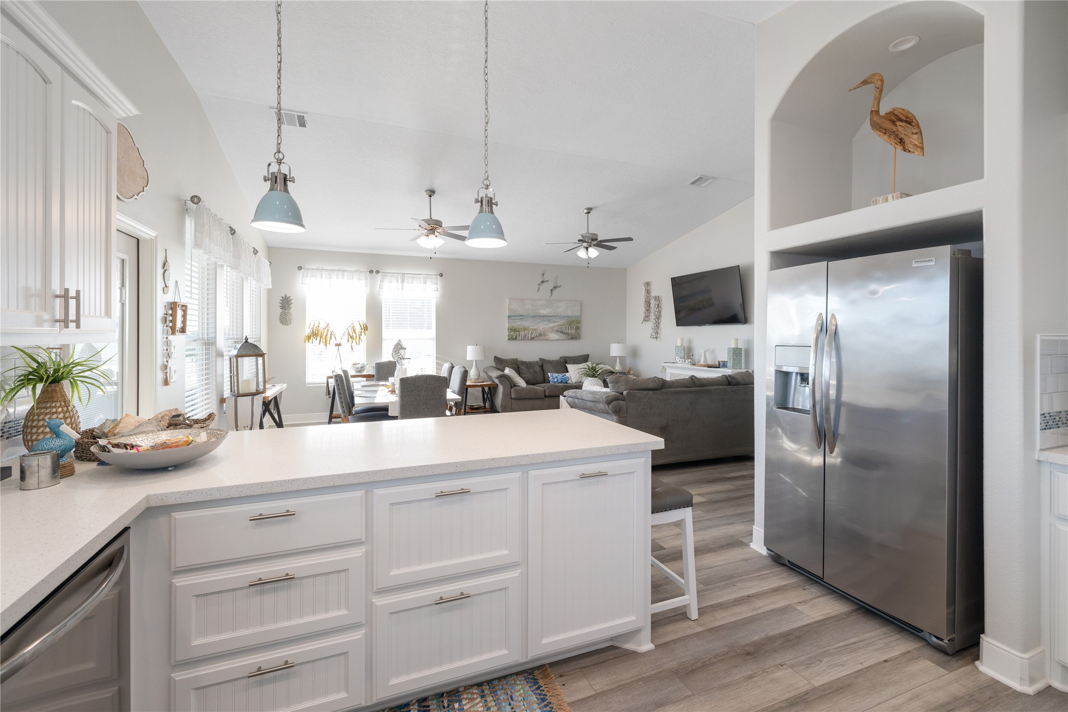 1286 Lagoon Drive Crystal Beach, TX 77650 - Photo 9 of 45 a kitchen with kitchen island white cabinets and refrigerator