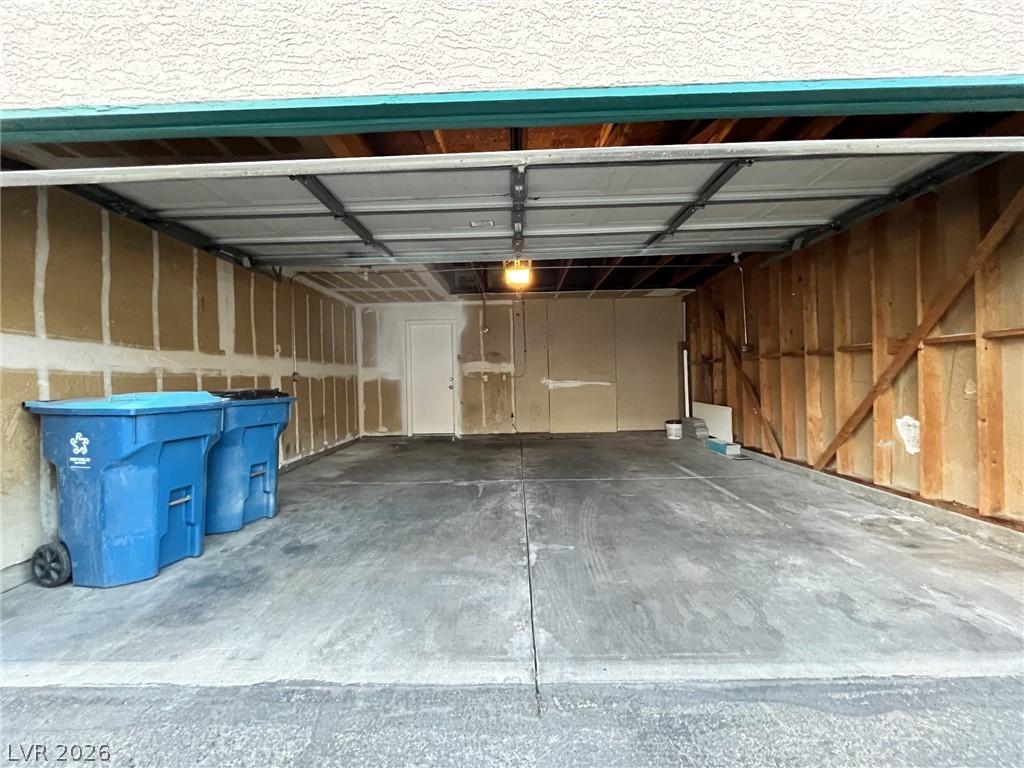 6750 Del Rey Avenue, Unit 123 Las Vegas, NV 89146 - Photo 21 of 21 A spacious garage provides ample utility space, featuring an automatic door for convenient access.