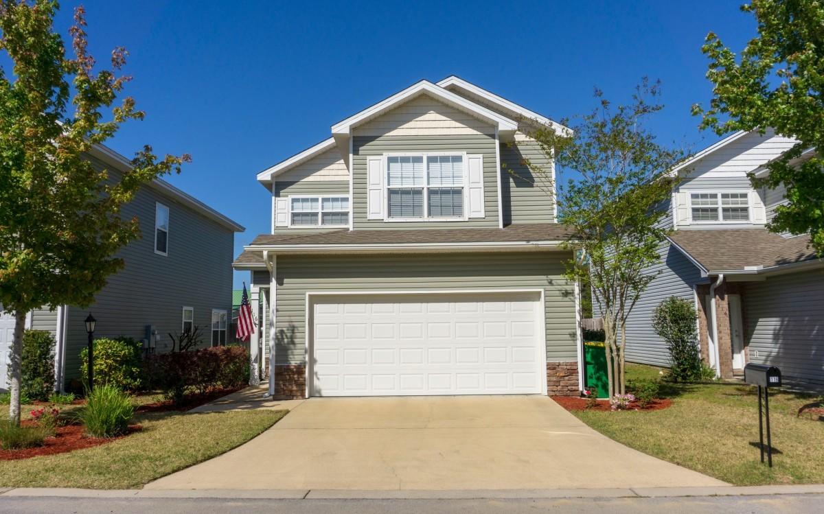 116 Matt Boulevard Niceville, FL 32578 - Photo 1 of 6 a front view of a house with a yard and garage