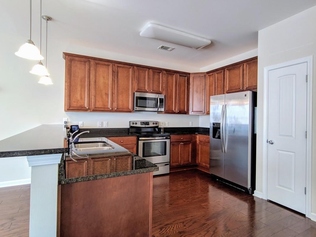 116 Matt Boulevard Niceville, FL 32578 - Photo 2 of 6 a kitchen with granite countertop a refrigerator sink and cabinets