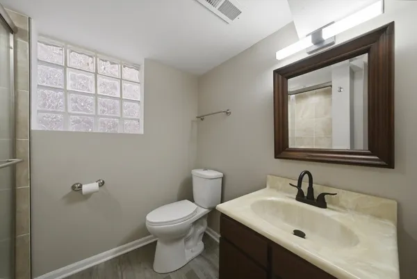 a bathroom with a glass shower door