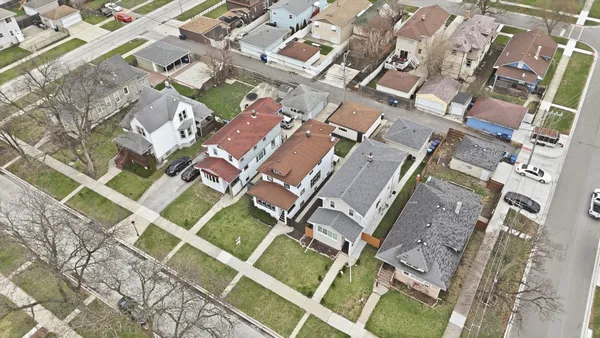 an aerial view of a residential apartment building with a yard