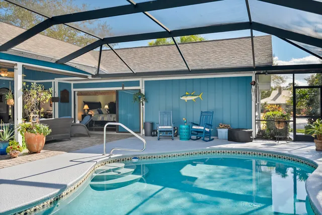a dining area with furniture and a chandelier