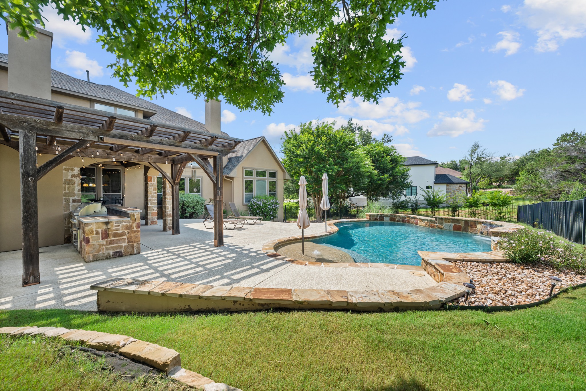1301 Lions Lair Leander, TX 78641 - Photo 34 of 40 Outdoor kitchen with built-in grill and dining space