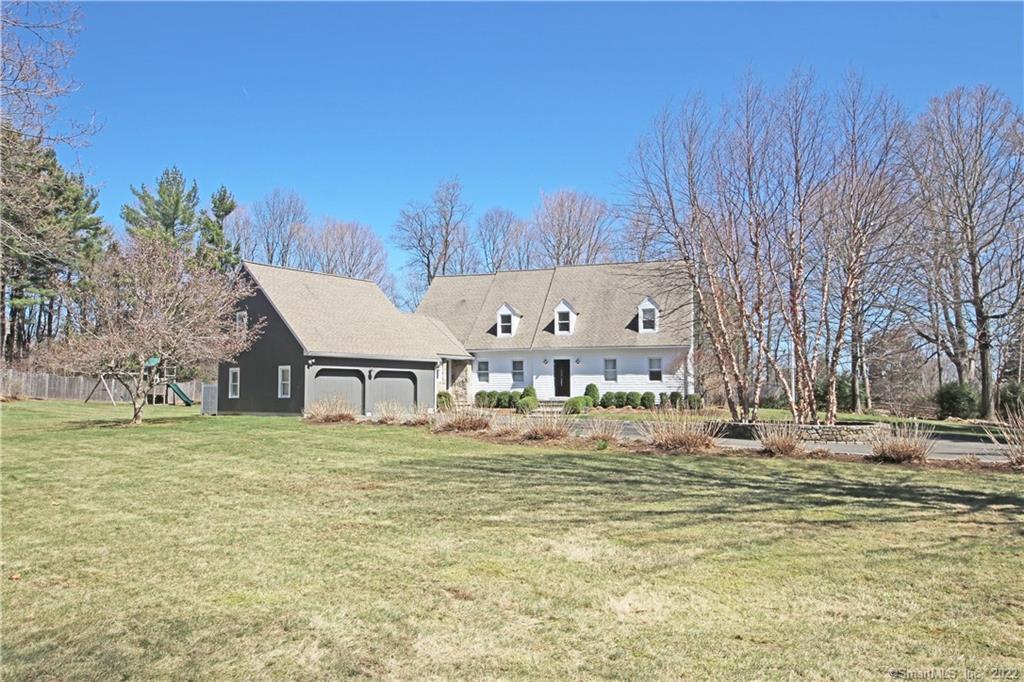 26 Oak Knoll Road Ridgefield, CT 06877 - Photo 1 of 1 a big white house with a big yard and large trees