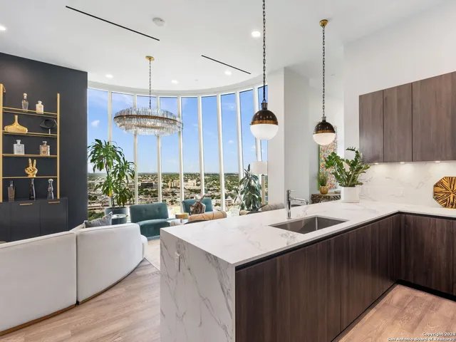 a kitchen with a sink a counter and chairs
