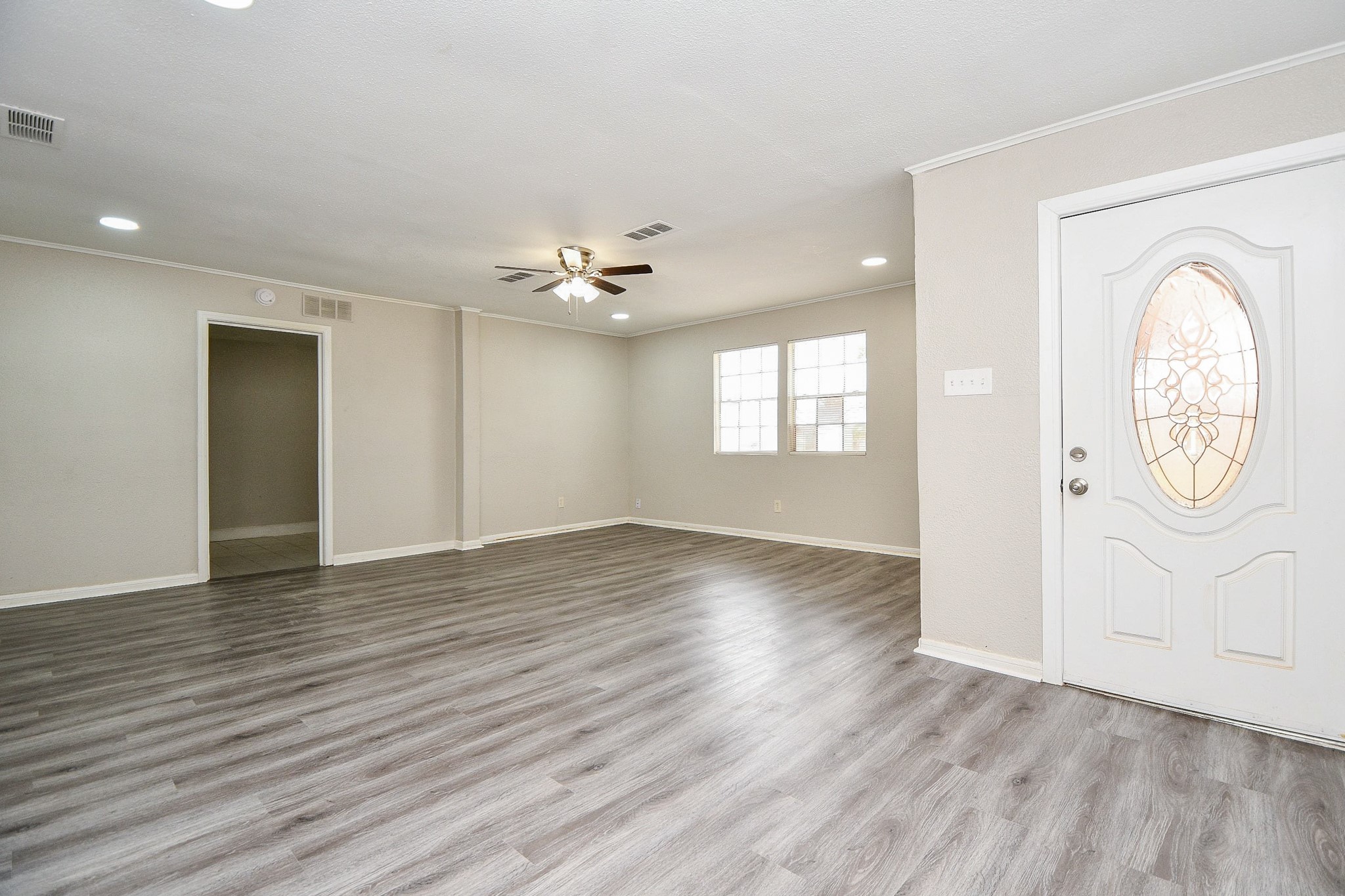 1606 Harris Avenue Pasadena, TX 77506 - Photo 3 of 20 Features a decorative front door, ceiling fan, and large windows for natural light.