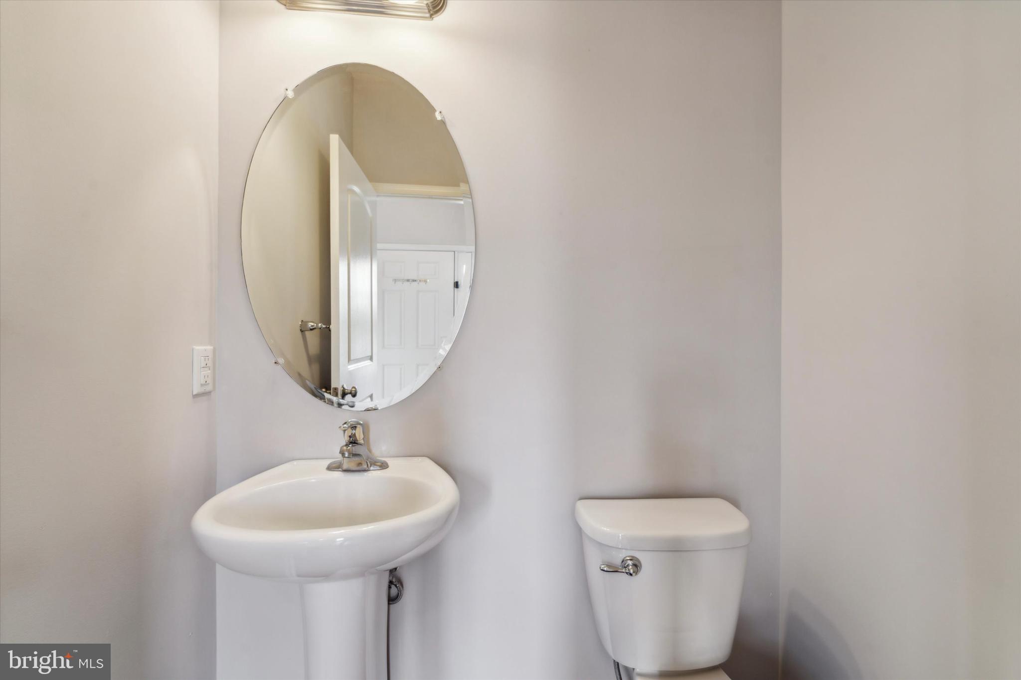 3799 Jacob Stout Road, Unit 5 Doylestown, PA 18902 - Photo 7 of 25 a bathroom with a toilet sink and mirror