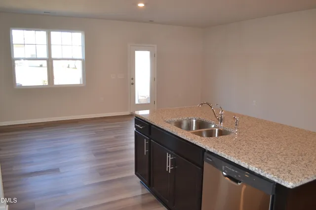 a bathroom with a granite countertop sink and a window