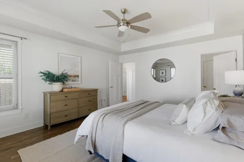 a bedroom with a bed and a chandelier