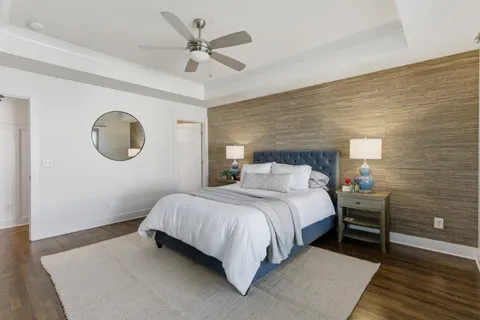 a bedroom with a large bed and a chandelier