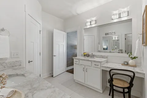 a spacious bathroom with a granite countertop sink a mirror and a