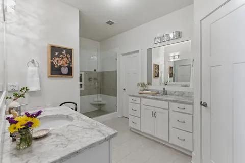 a spacious bathroom with a granite countertop sink a mirror and a