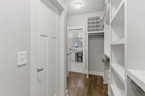 a view of closet with wooden floor