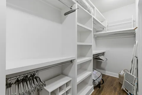 a view of walk in closet with empty racks