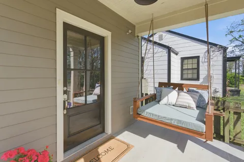 a view of a bedroom with a bed and glass door