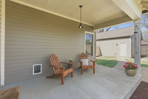 a bedroom with a chair and a table