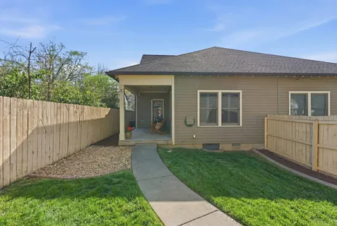 a view of a house with a yard and a garden