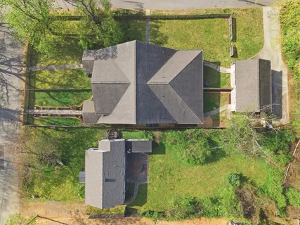 an aerial view of a house with a garden and a yard