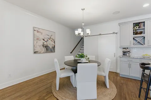 a view of a dining room with furniture wooden floor and a chandelier