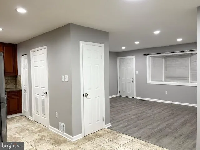 an empty room with closet and windows