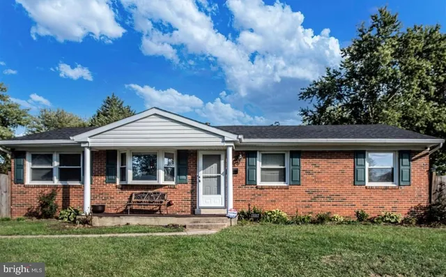 a front view of a house with a yard table and chairs