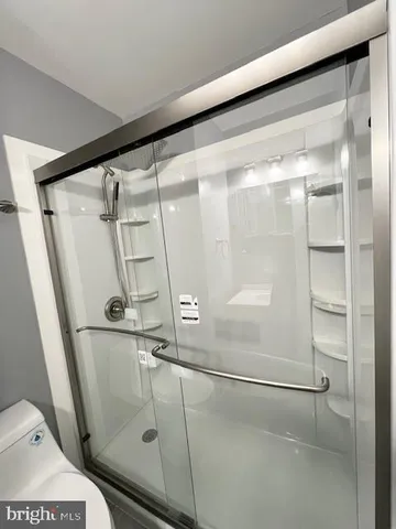 a bathroom with a glass shower door