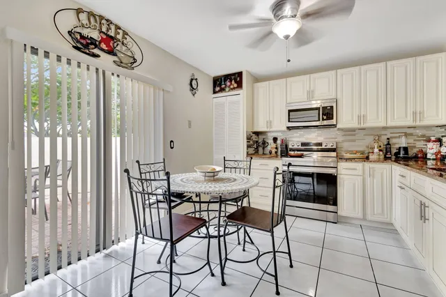 a kitchen with stainless steel appliances kitchen island granite countertop a stove a sink and a microwave