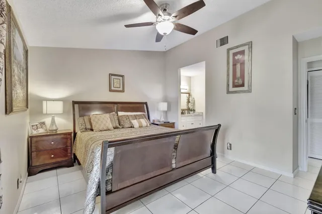 a bedroom with a bed and a lamp