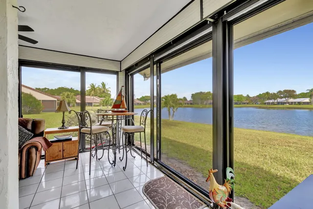 a view of a house with a garden and lake view