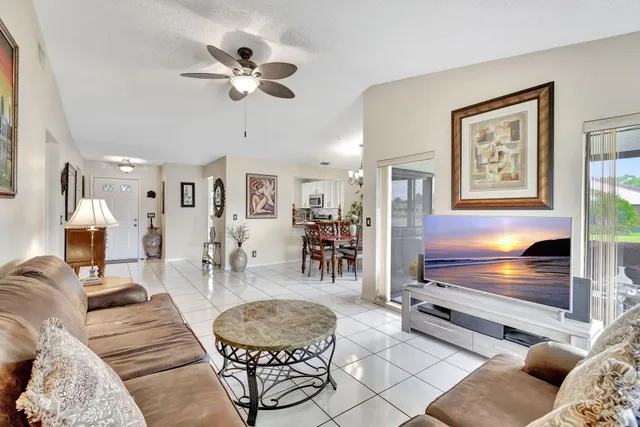 a living room with furniture a dining table and a fireplace