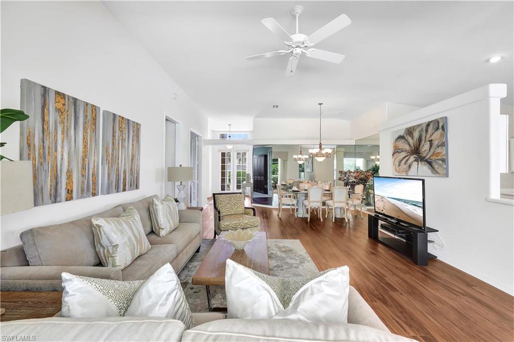 1721 Marsh Run Naples, FL 34109 - Photo 14 of 35 a living room with furniture fireplace and a chandelier