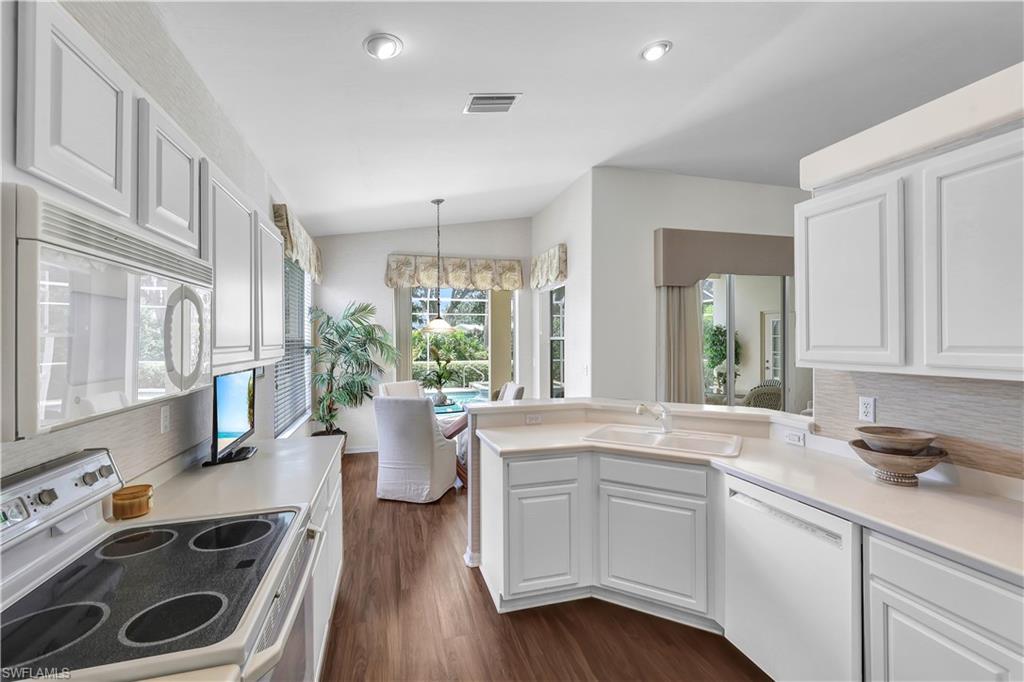 1721 Marsh Run Naples, FL 34109 - Photo 18 of 35 a kitchen with a stove a sink and a refrigerator