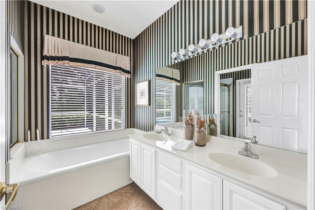 1721 Marsh Run Naples, FL 34109 - Photo 23 of 35 a bathroom with a bathtub and a sink