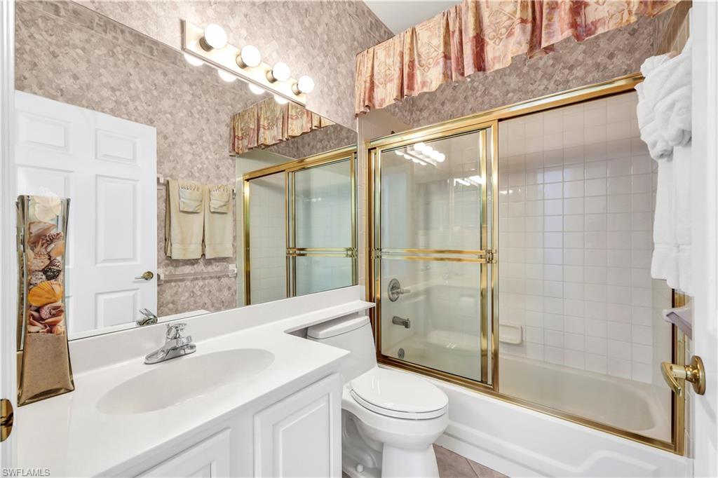 1721 Marsh Run Naples, FL 34109 - Photo 26 of 35 a bathroom with a sink mirror toilet and shower