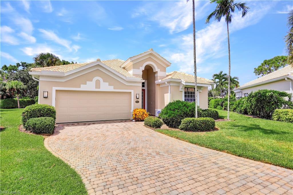 1721 Marsh Run Naples, FL 34109 - Photo 4 of 35 a front view of a house with a yard and garage