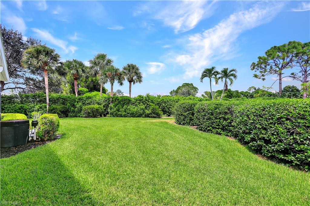 1721 Marsh Run Naples, FL 34109 - Photo 6 of 35 a view of a garden with a building in the background